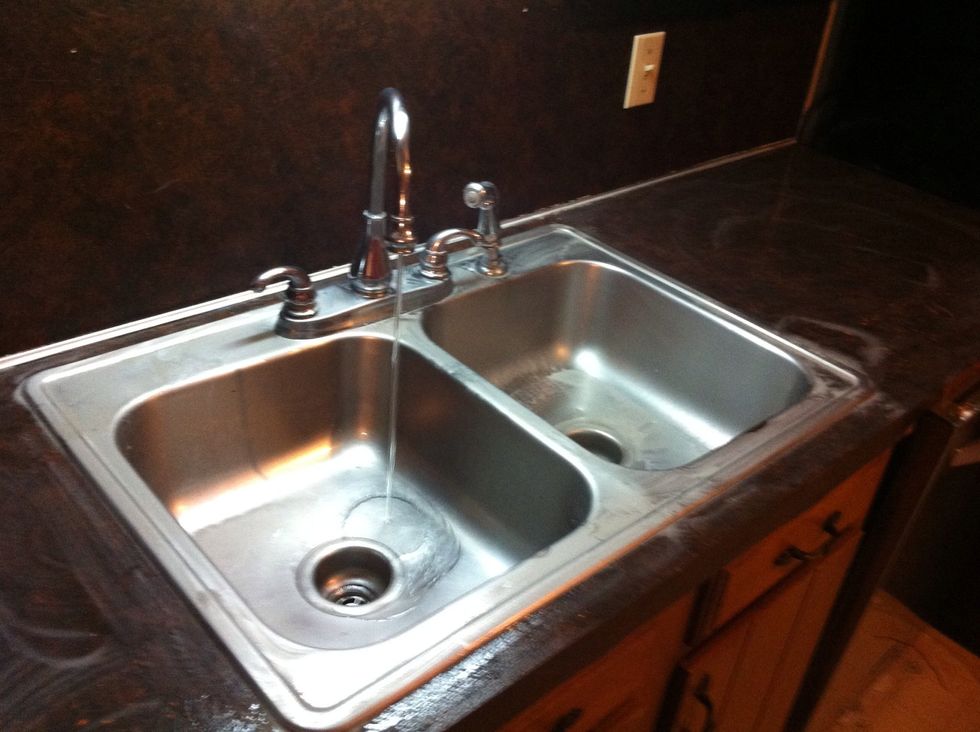 Keep the water running just a little to frequently rinse off dishcloth.