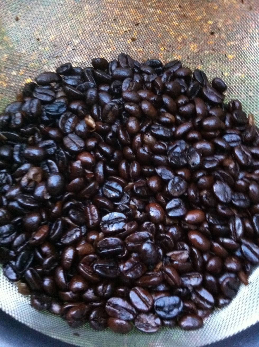 Keep tossing beans until they cool down enough to handle (they WILL be hot at first!). Notice the chaff has blown away (I do this outside over the edge of my deck).