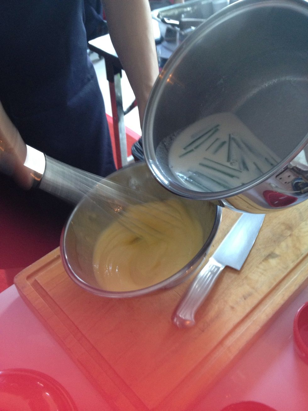 Keep whisking and add the milk mixture a little by little (tempering) never stop whisking or u'll get scramble eggs.