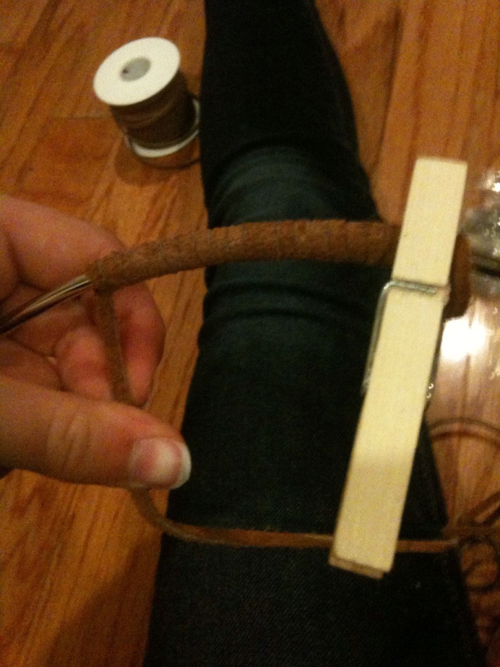 Keep wrapping the leather around the ring and use clothe pins to keep the leather tight and in place.