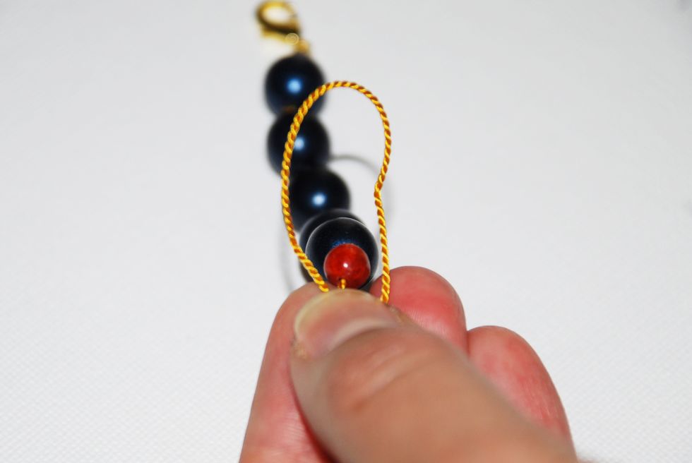 Keep your loop in place by holding it firm with your fingernail.