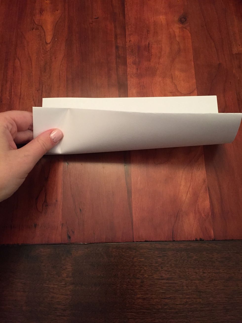 Keep your paper folded and fold a second time the same way.