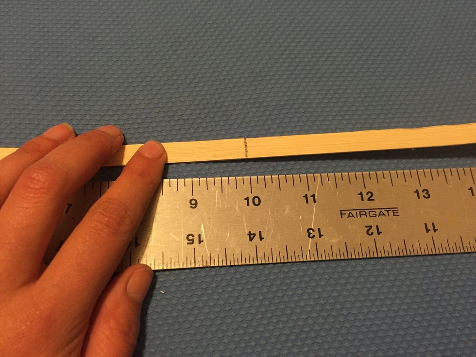 Keep your spoke lined up properly with the ruler and find the MIDDLE of your spoke. Make a mark at the middle! Repeat with each spoke. You'll need at least ten depending on the size of your basket