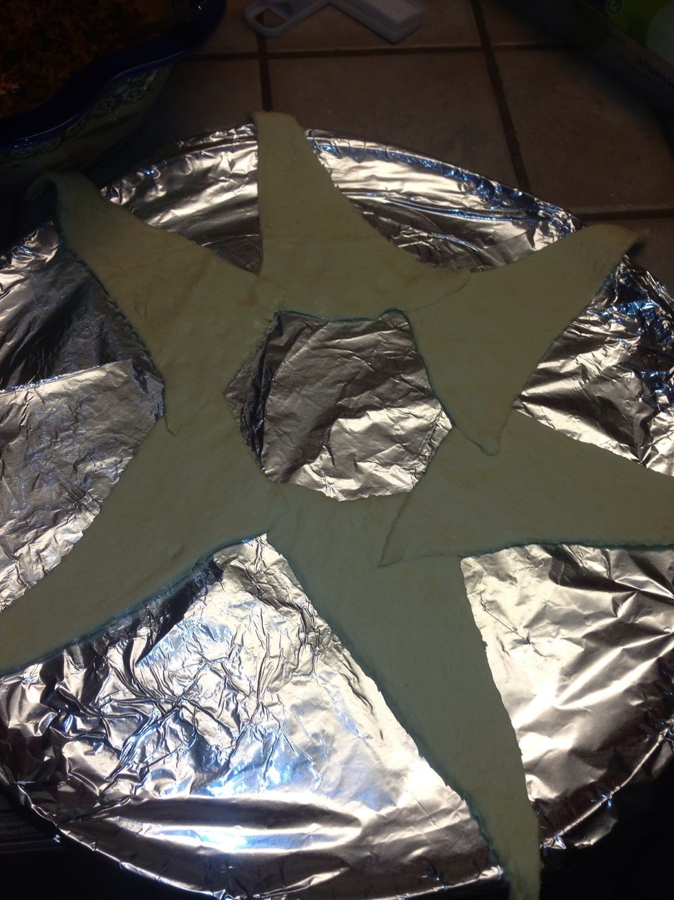 Keeping adding the crossaints making sure to press the tips together until you have made a complete circle. The farther apart you lay them the more you will need. I make a smaller one tonight.