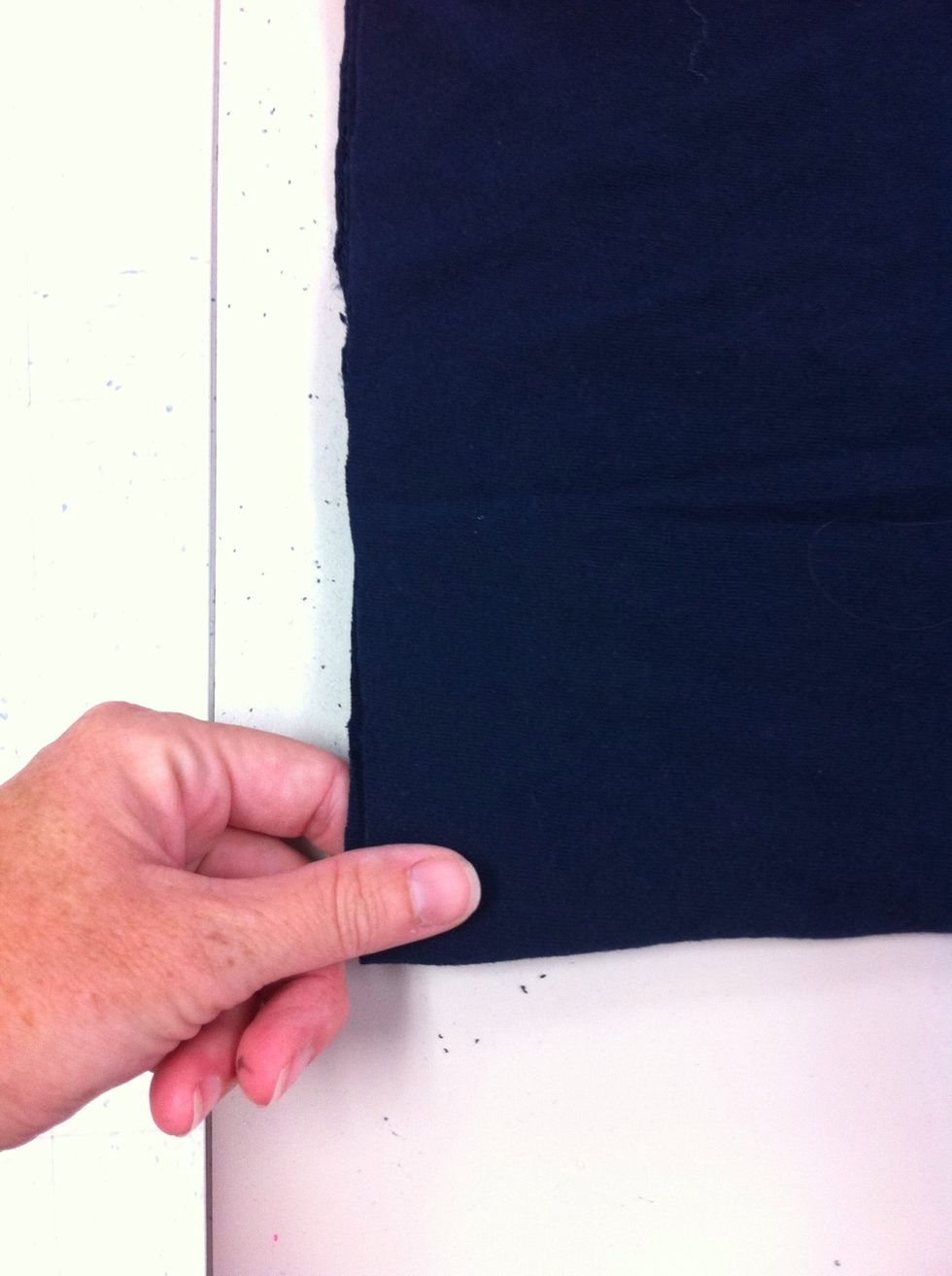 Keeping the shirt folded in half, cut the shirt into strips.