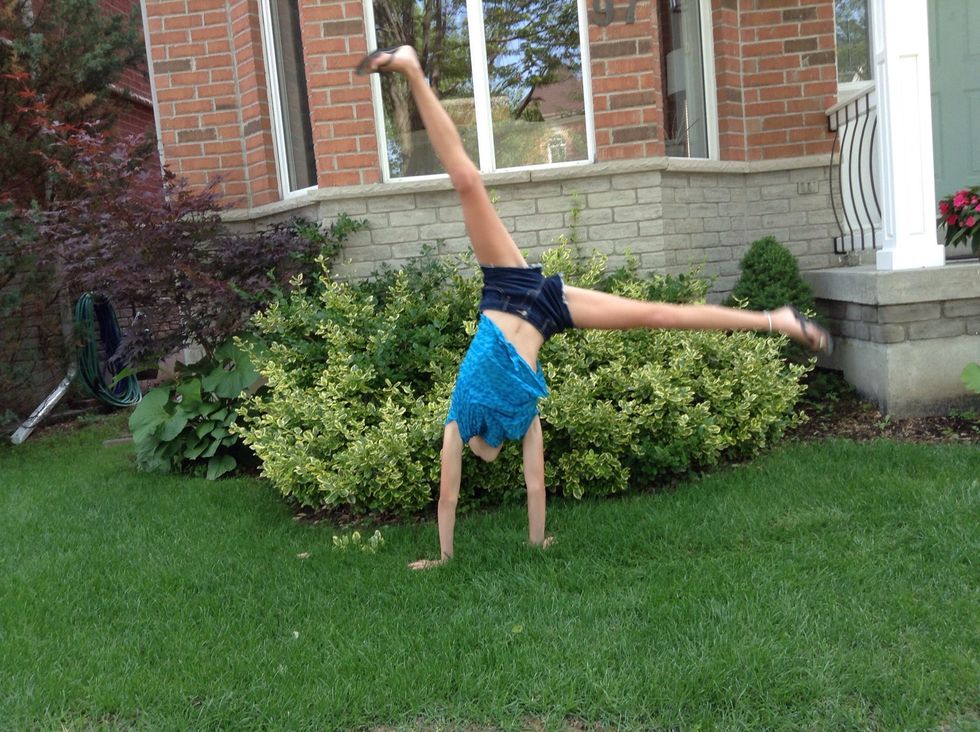 Kick both legs up and go into a straddle handstand