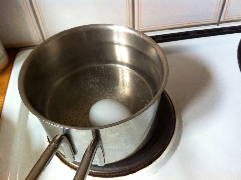 (Kind of) Boil an Egg for 3 minutes. Pick it up and pour some cold water over it to cool it down. I almost boil it, on 4/6 of the maximum heat.