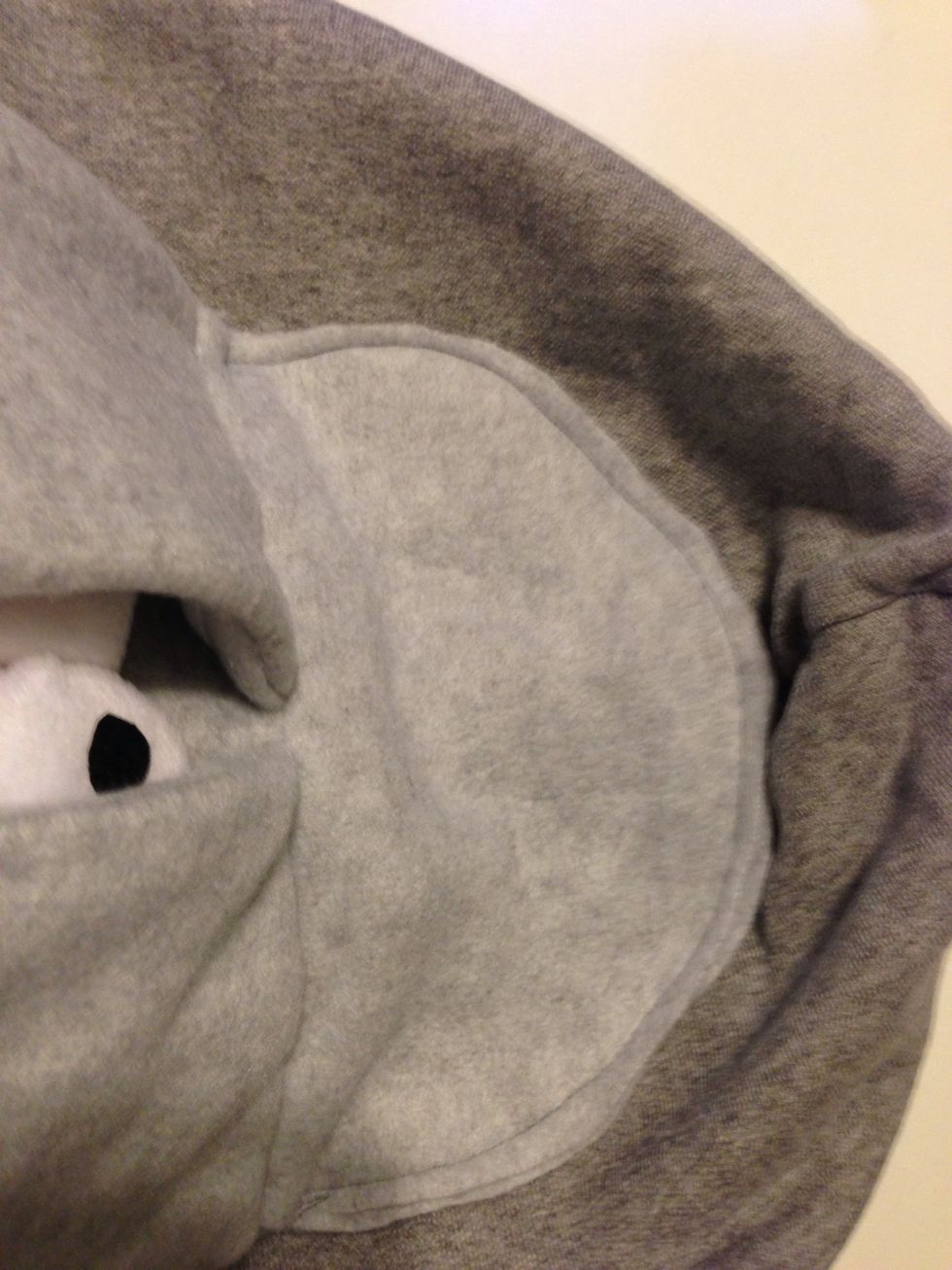 Kk now sew the bottoms together like so. In this pic i am now taking the top of the hood, flatten it down and placing the donkey head in to see where to glue it down.