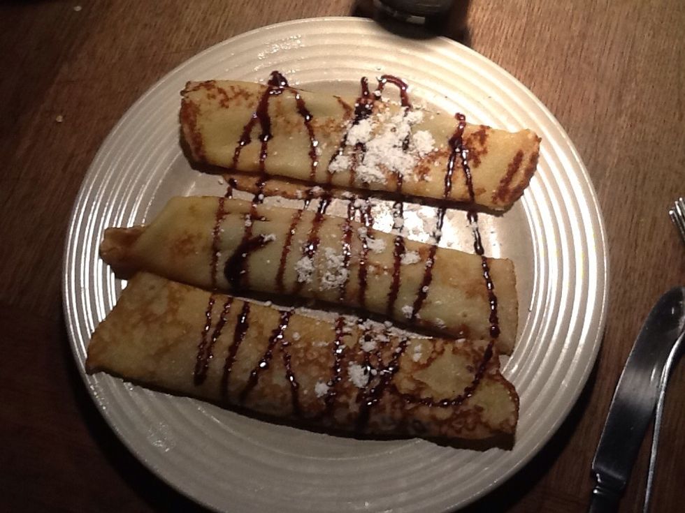 Kleta nutella on the pancakes roll it and then you take chocolate.