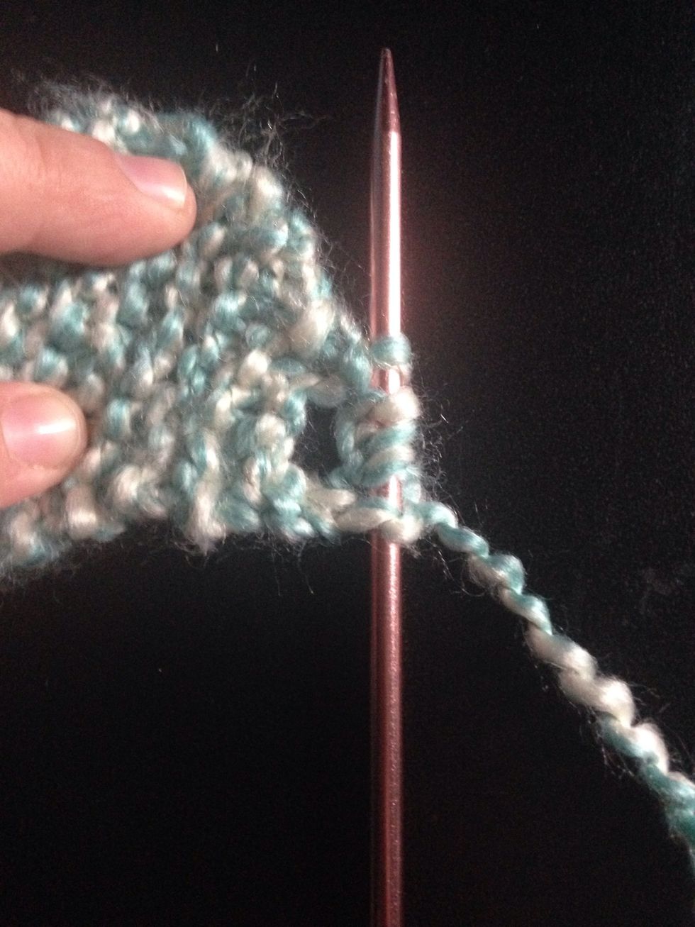 Knit one, make three stitches by looping the needle with your yarn to make 5 stitches on your needle