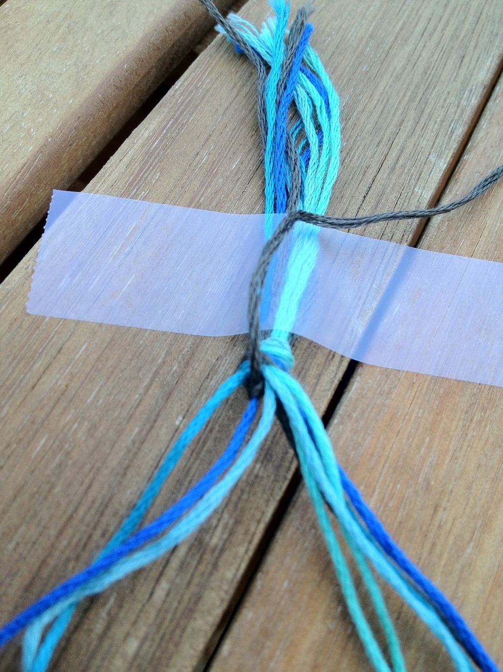 Knot each string twice. This is what it should look like after the first and second string is knotted twice.