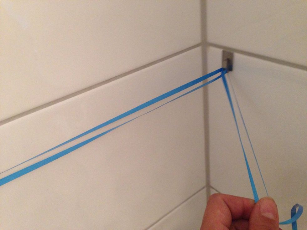 Knot ribbon at the other hook, make sure it's tightly hung