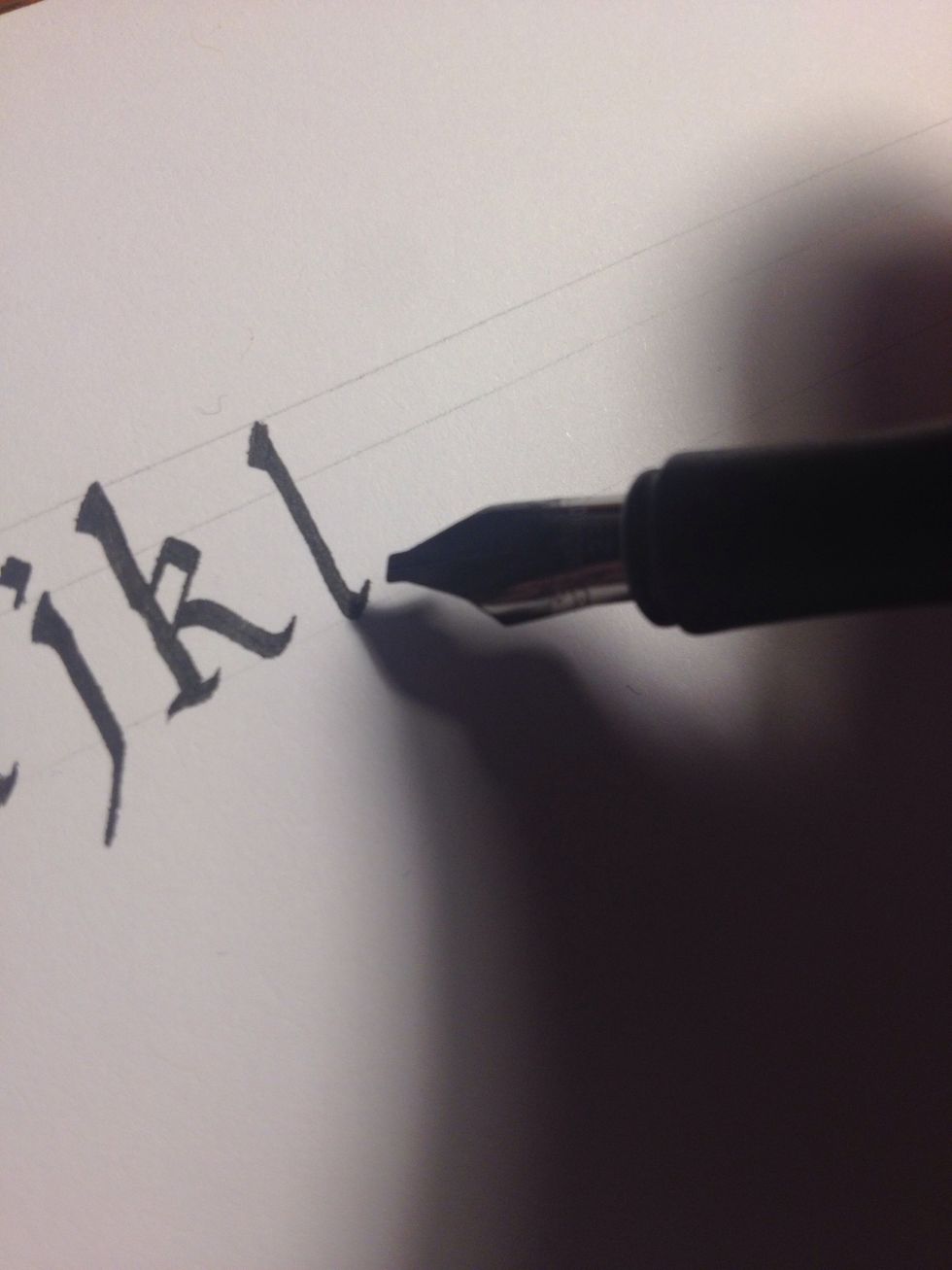 "L" is perhaps the simplest of all; one stroke, a tall stalk with an upward curve at the foot, with a standard triangle embellishment.