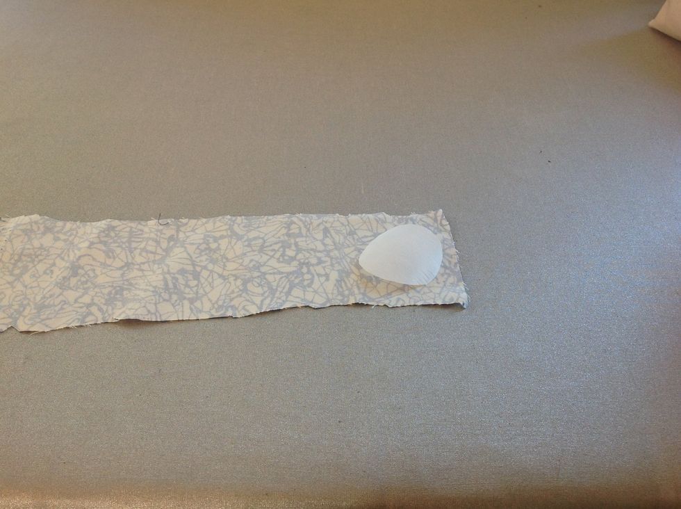 L\u00e4gg vliesofixbiten med limsidan mot avigsidan (baksidan) mot det tyg du har valt. T\u00e4nk p\u00e5 att l\u00e4gga biten i kanten p\u00e5 tyget s\u00e5 att du inte sl\u00f6sar tyg i on\u00f6dan.