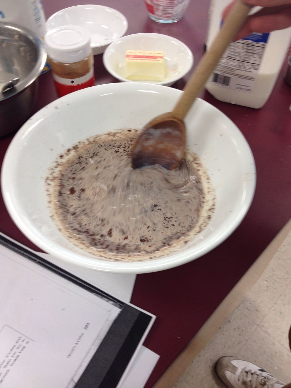 Ladle 1 cup of the simmering milk over the chocolate in a heatproof bowl. let sit 1 minute, then whisk to dissolve the chocolate.