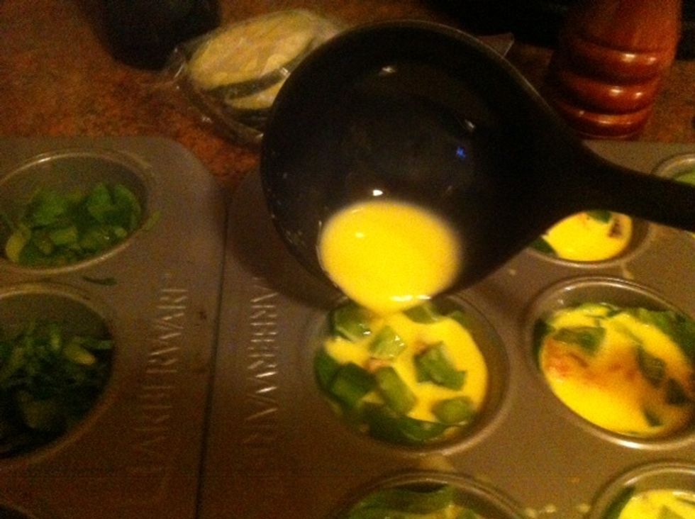 Ladle egg and milk mixture to prepared muffin cups.