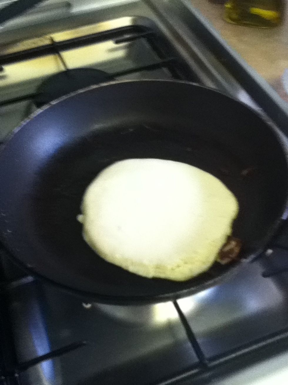 Ladle in pancake and spread around the pan
