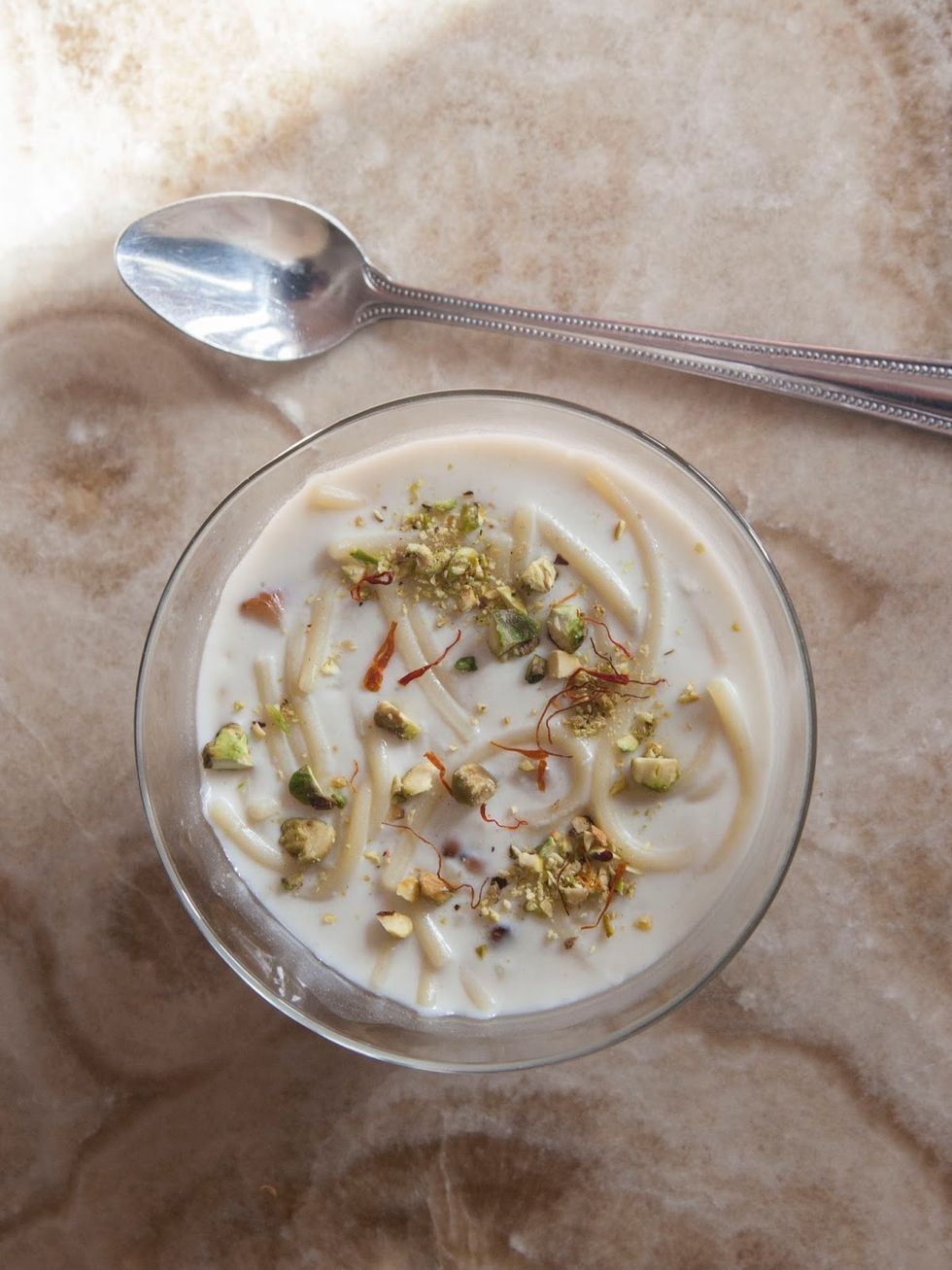 Ladle it into serving dishes or bowls. Sprinkle the top with a bit of crumbled saffron and finely chopped pistachio and serve it up!