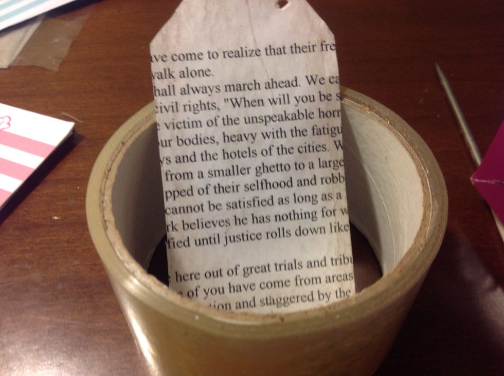 Laminate it with packaging tape if you don't have a laminator, or just use a laminator. Poke a hole in it with a hole puncher or a pencil.