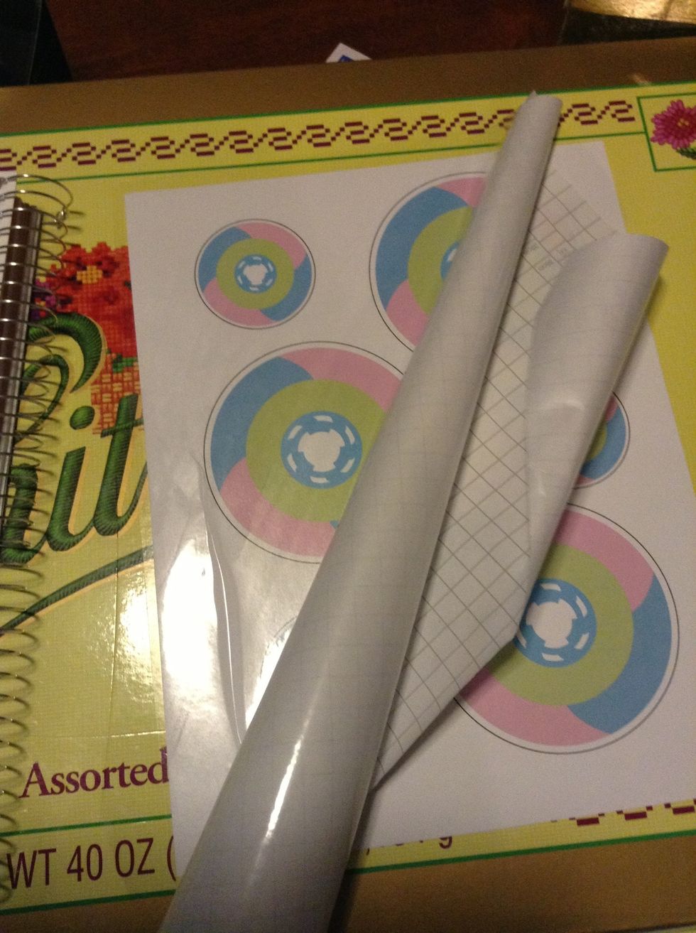 Laminate the sticker paper. Ensure that bubbles don't form over the image. Any bubbles that form in the areas outside of the image don't matter. They'll be removed later.