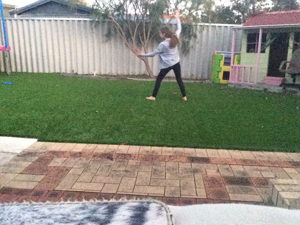 Land like a normal cartwheel, non preferred leg first then preferred leg second.