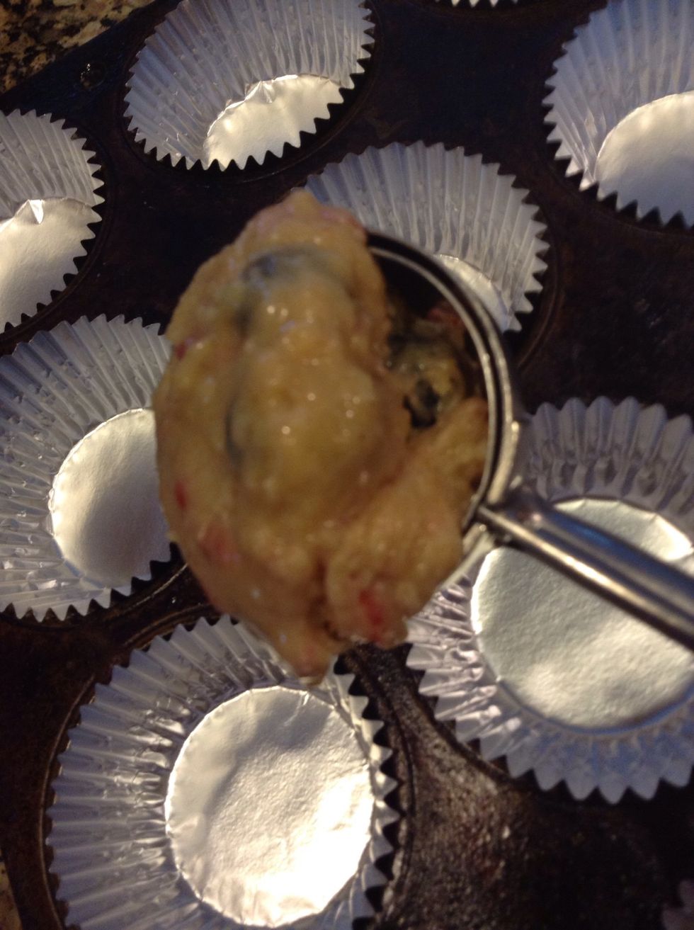 Large scoops into the muffin tins.