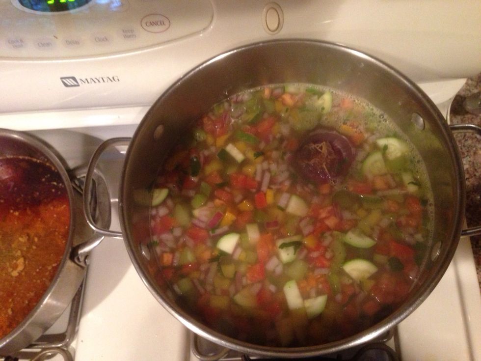 Last add the tomatoes and cilantro bring back to a boil and turn off, add salt if needed. (That's a purple onion remove when done)