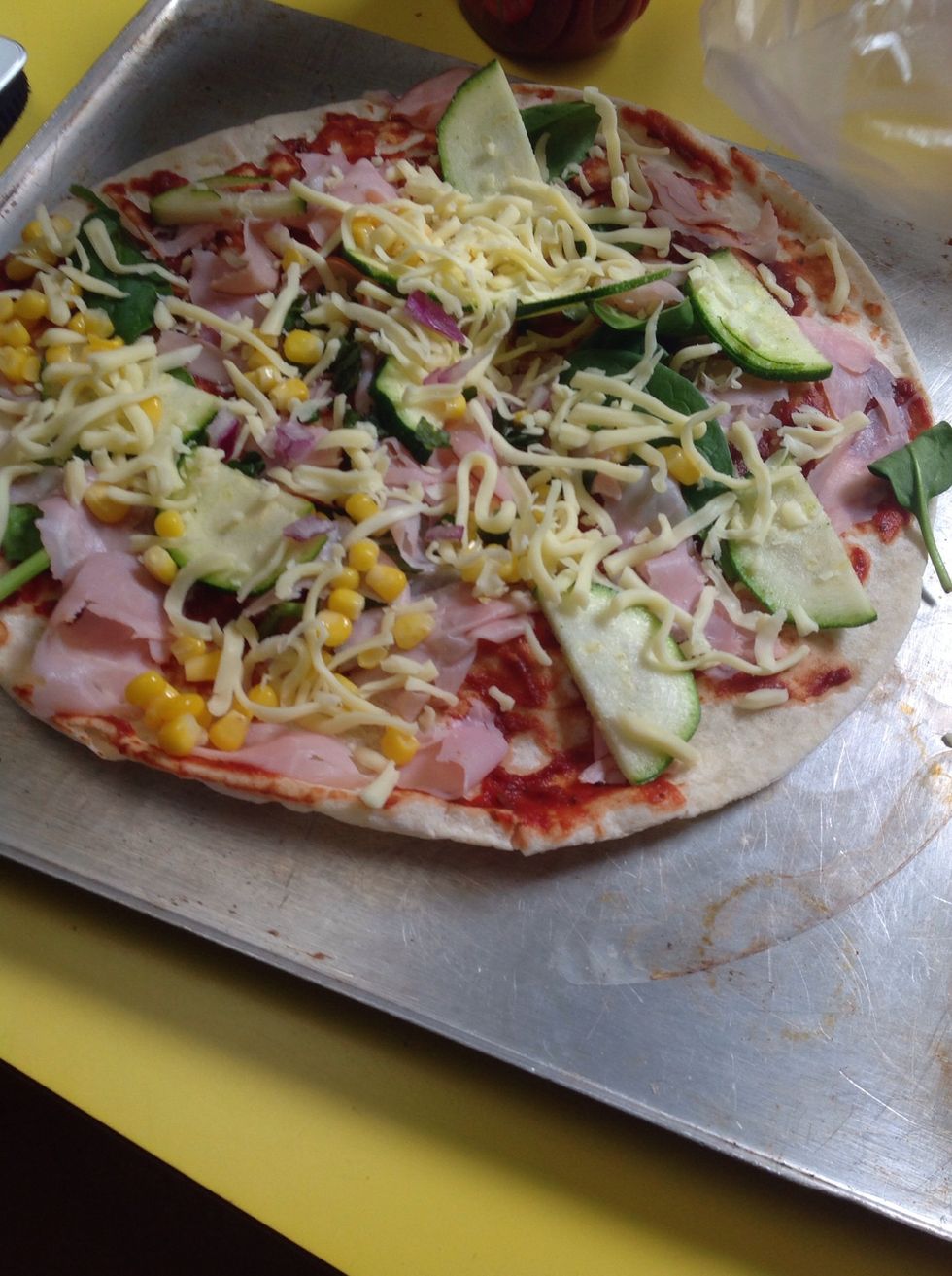 Last but not least sprinkle some cheese on your pizza