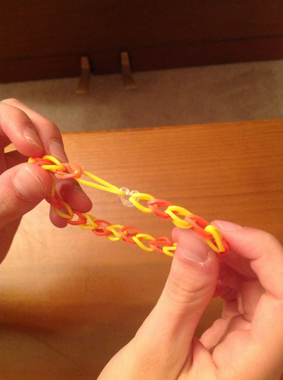 Last but not least, take a c-clip and put the rubber bands on the two ends of the chain of rubber bands in the c-clip. You now have a standard rainbow loom bracelet!