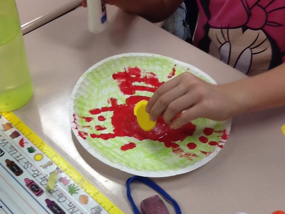 Last, glue the three seeds in the middle of the handprints.