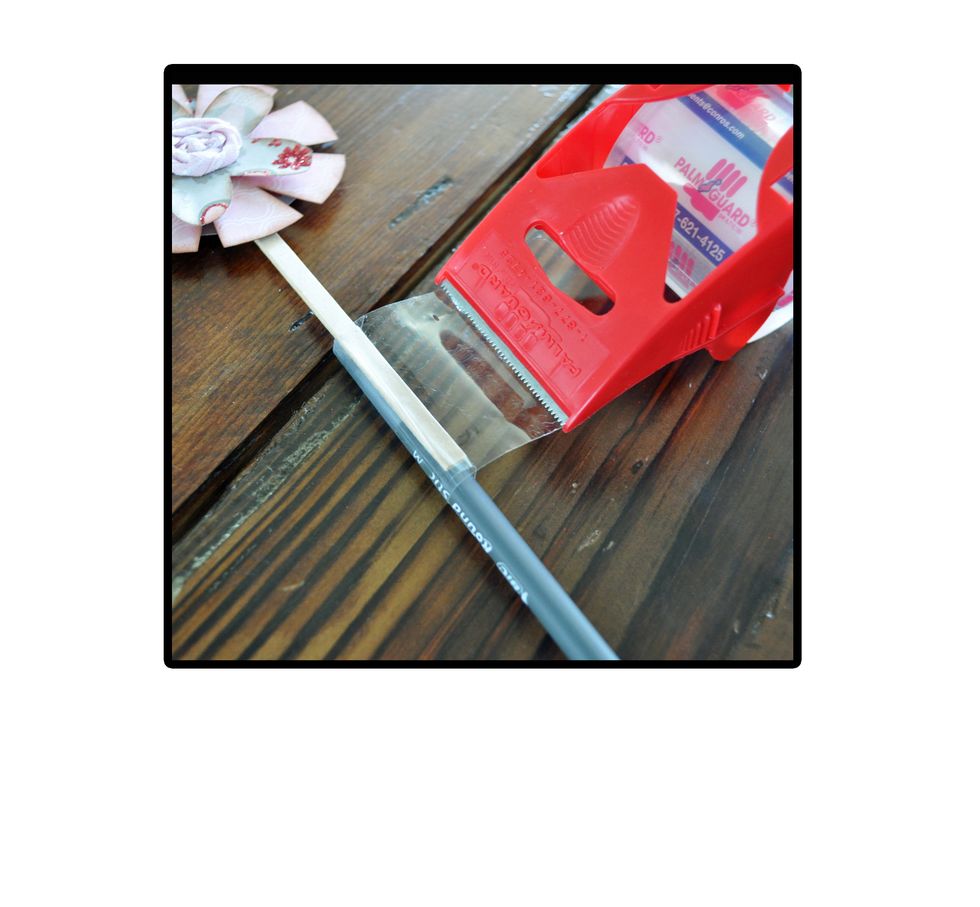 Last thing to do is add it to the pen. Place the top few inches of the pen against the bottom few inches of the craft stick and tape in place.