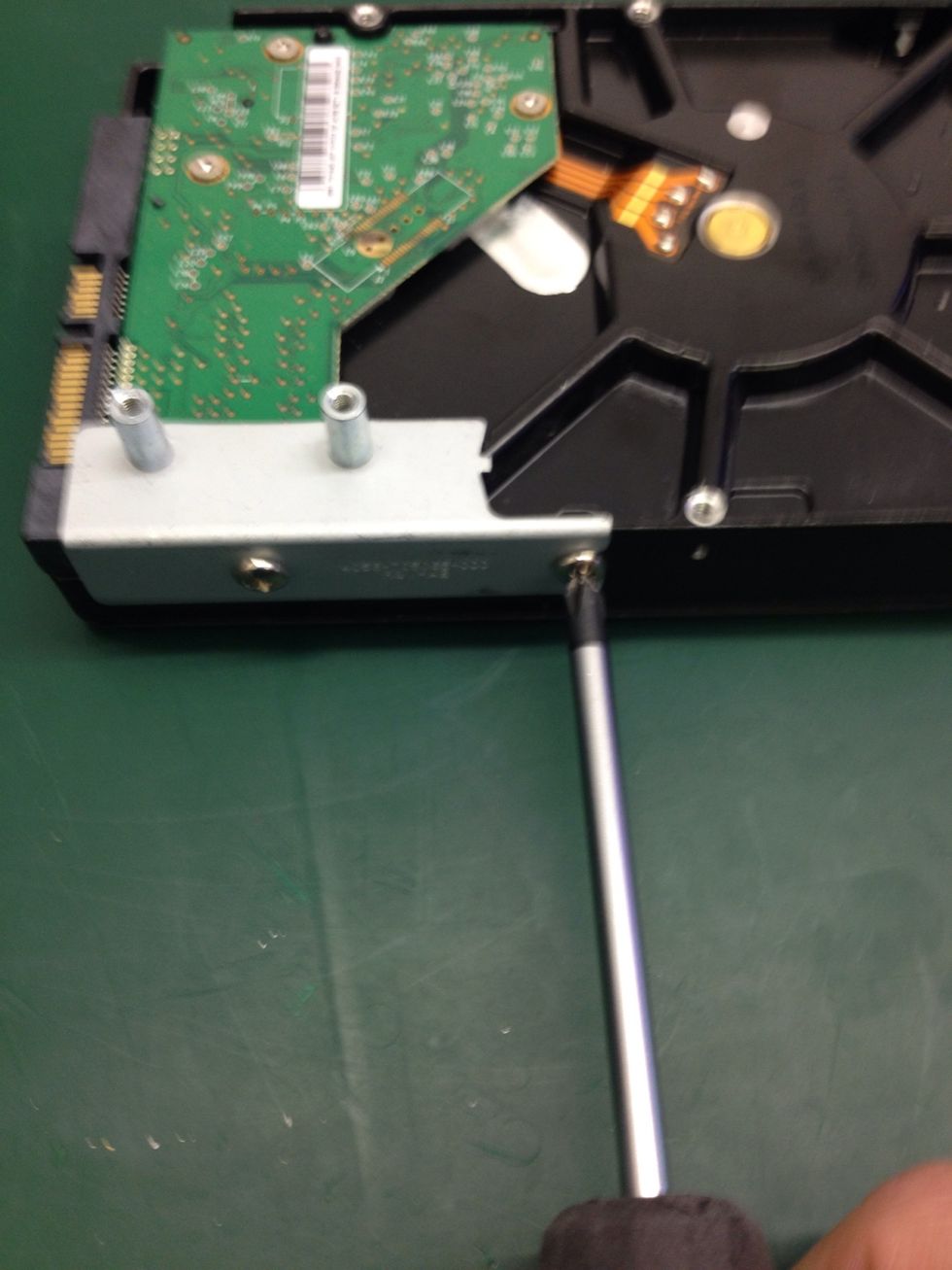 Last two screws in the side of the drive need to be removed. Keep them separated from the previous two as they are different.