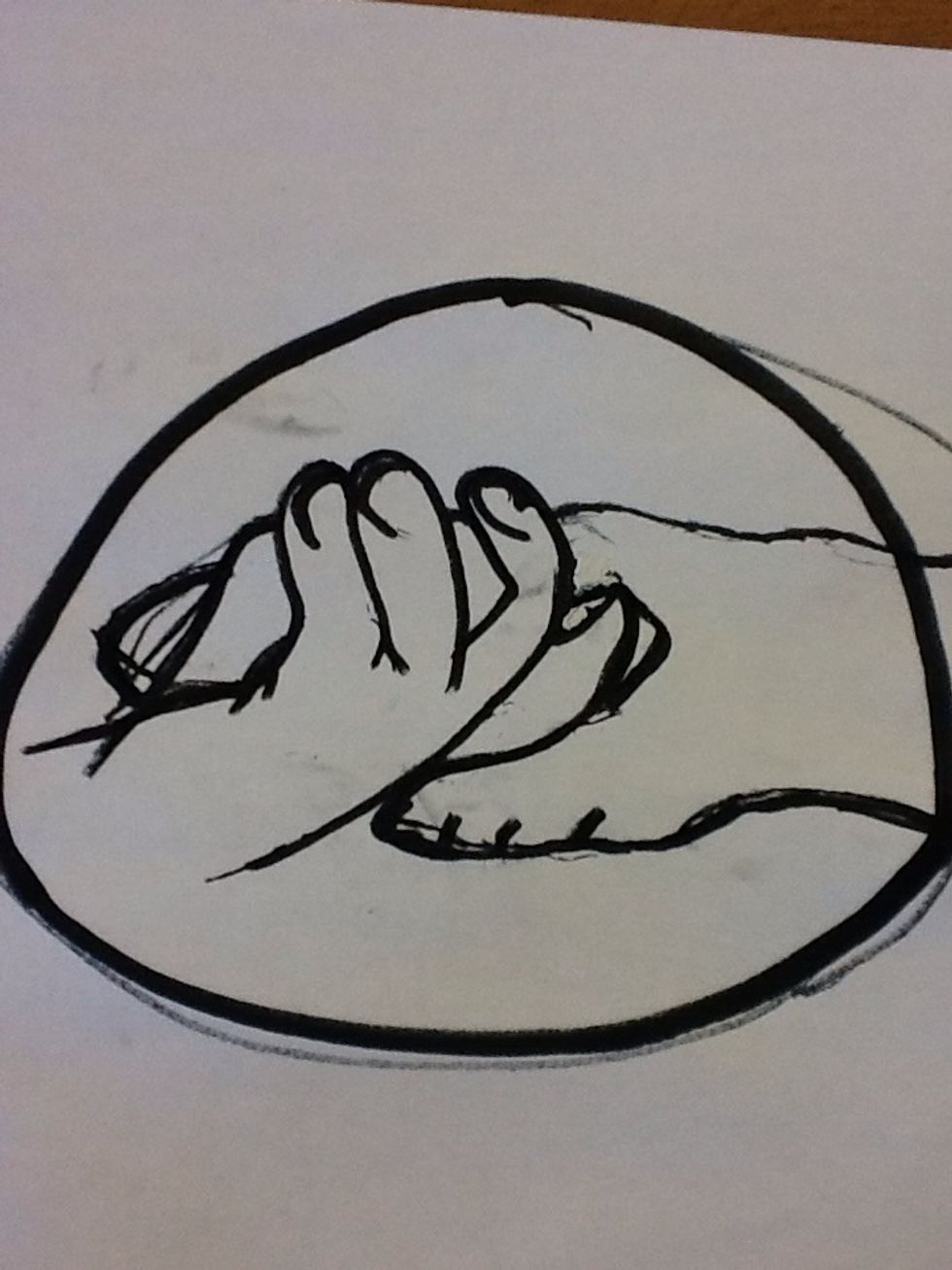 Lastly, begin sketching out the top hand and then draw the thumb, and a couple of the visible fingers. Add detailing to the hands which also includes the nails. Then draw the circle