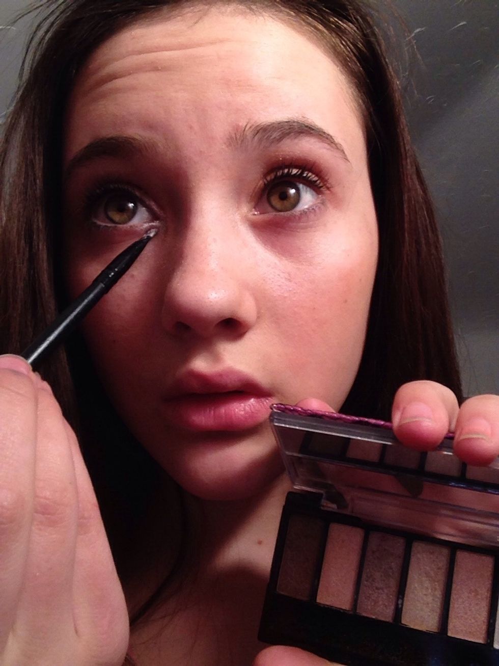 Lastly, for the eyeshadow, now to highlight and brighten the look add a very bright and shimmery white to the inner corner using a small flat brush.