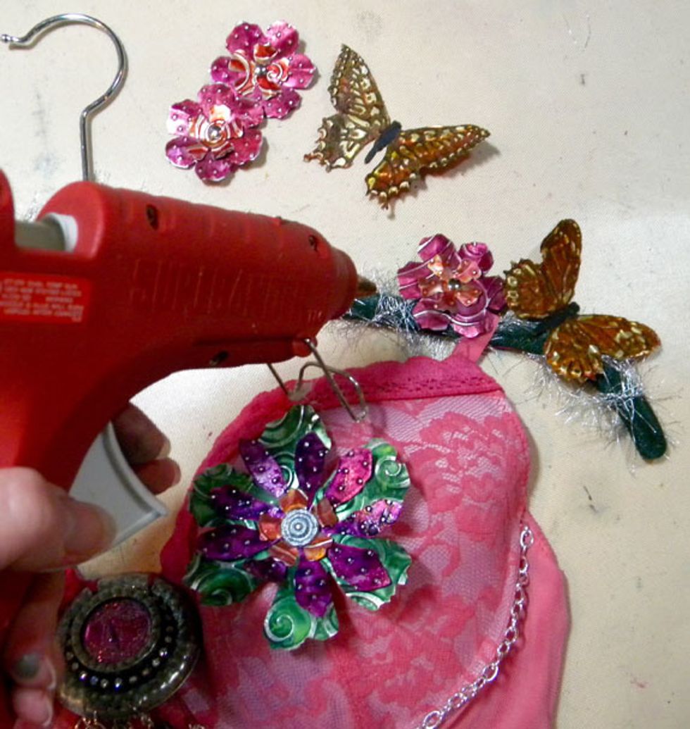 Lastly, hot glue the flowers and butterflies onto the hanger.
