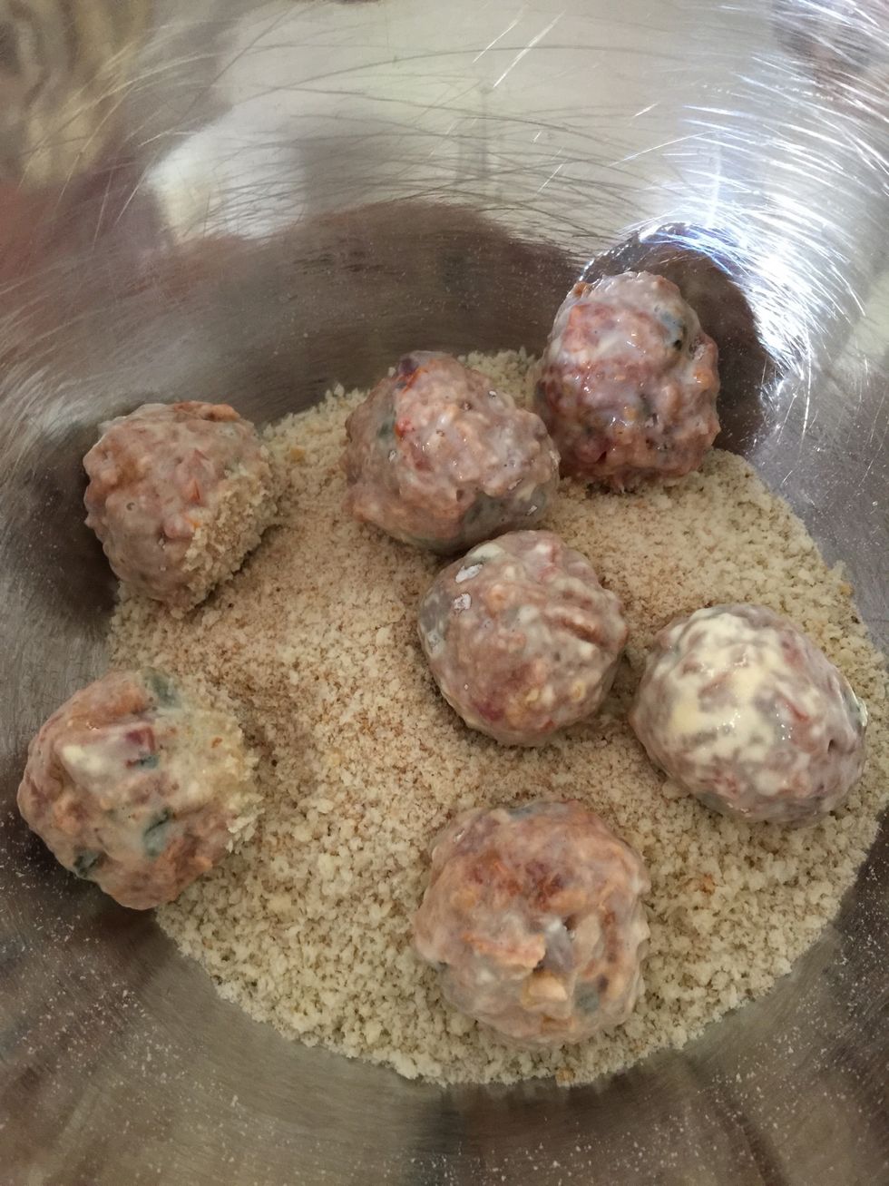 Lastly, place into bread crumbs and roll to coat, gently squeezing the ball to ensure as much crumbs will stick to it as possible.