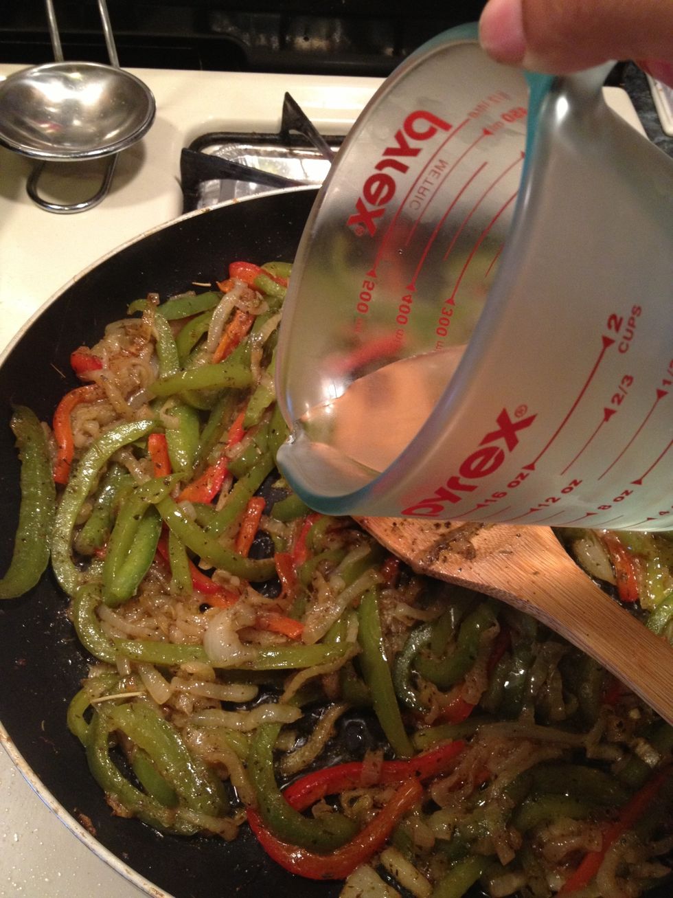 Lastly, the white wine. I usually use what I have at home. I had no red wine so I used white. Both are very tasty.. Let's cook this until the wine has evaporated and has flavored the vegetables.