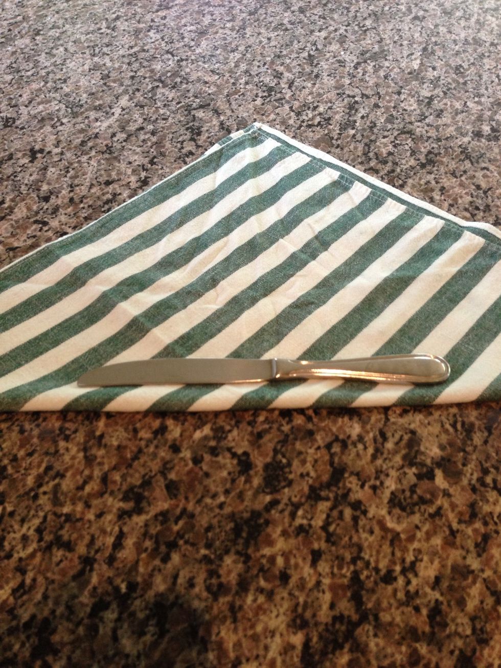 Lay a butter knife toward the edge of the fold. I would recommend NOT using sharp knives, machetes, or steak knives in the roll-ups. Your dinner guests do not want to be attacked by cutlery.