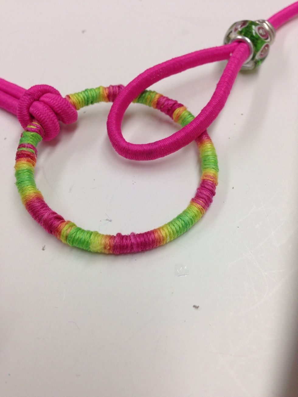 Lay a loop end on TOP of the wrapped ring.