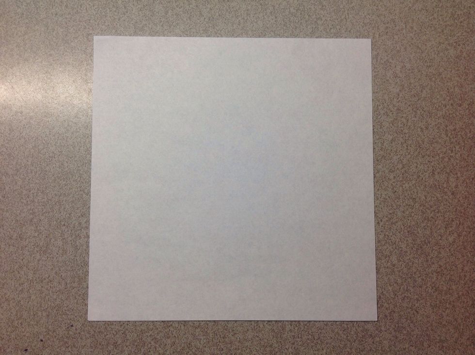 Lay a patterned origami paper on the table, patterned side down.