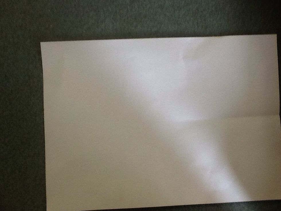 Lay a piece of A4 paper on a flat surface.