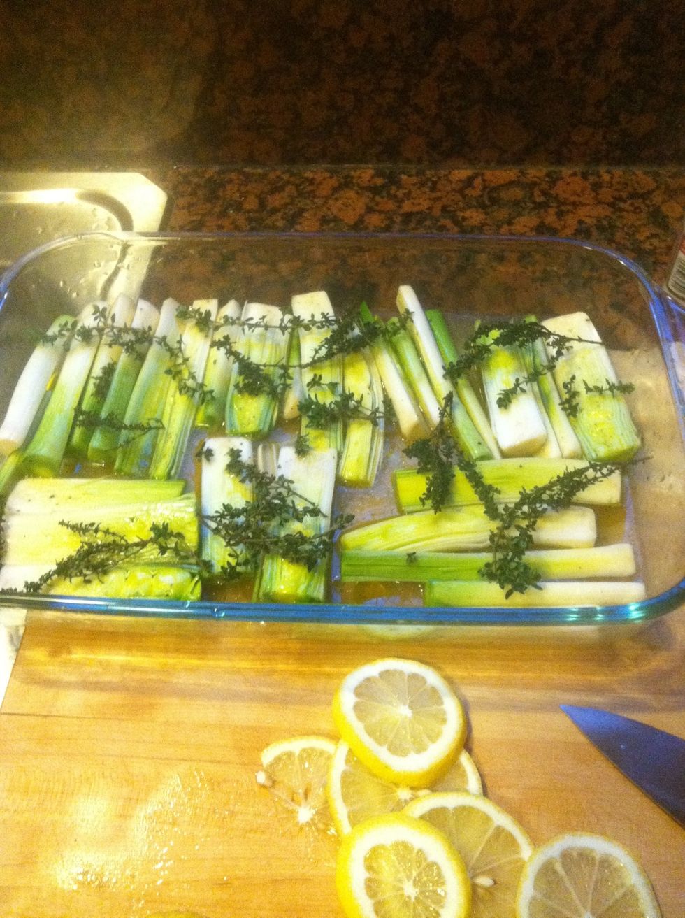 Lay about 20 springs of thyme over the leeks. You'll be removing them later, so don't de-leave or worry about separating them too much.