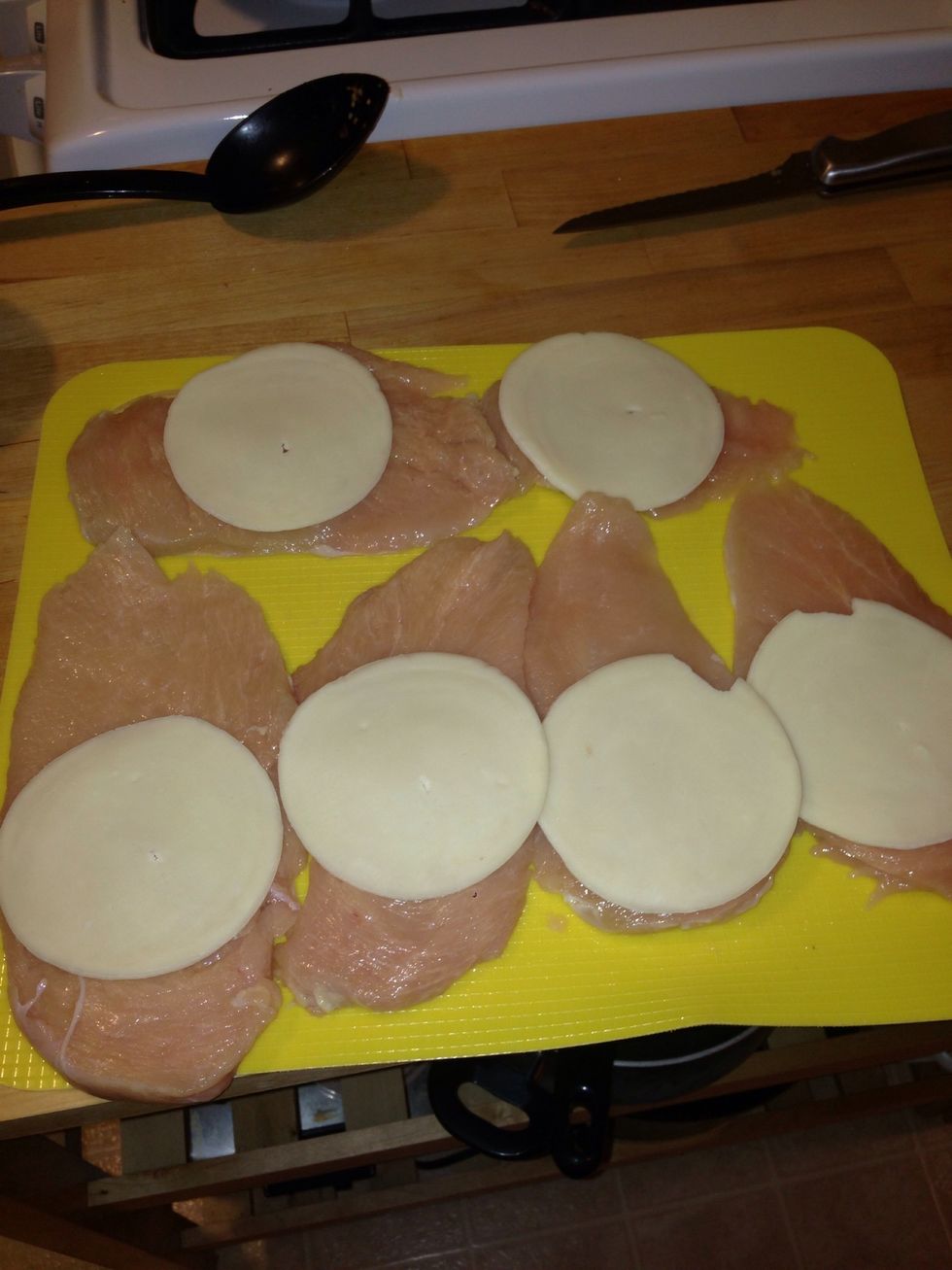 Lay all of the chicken breast face up and add the slice of provolone.