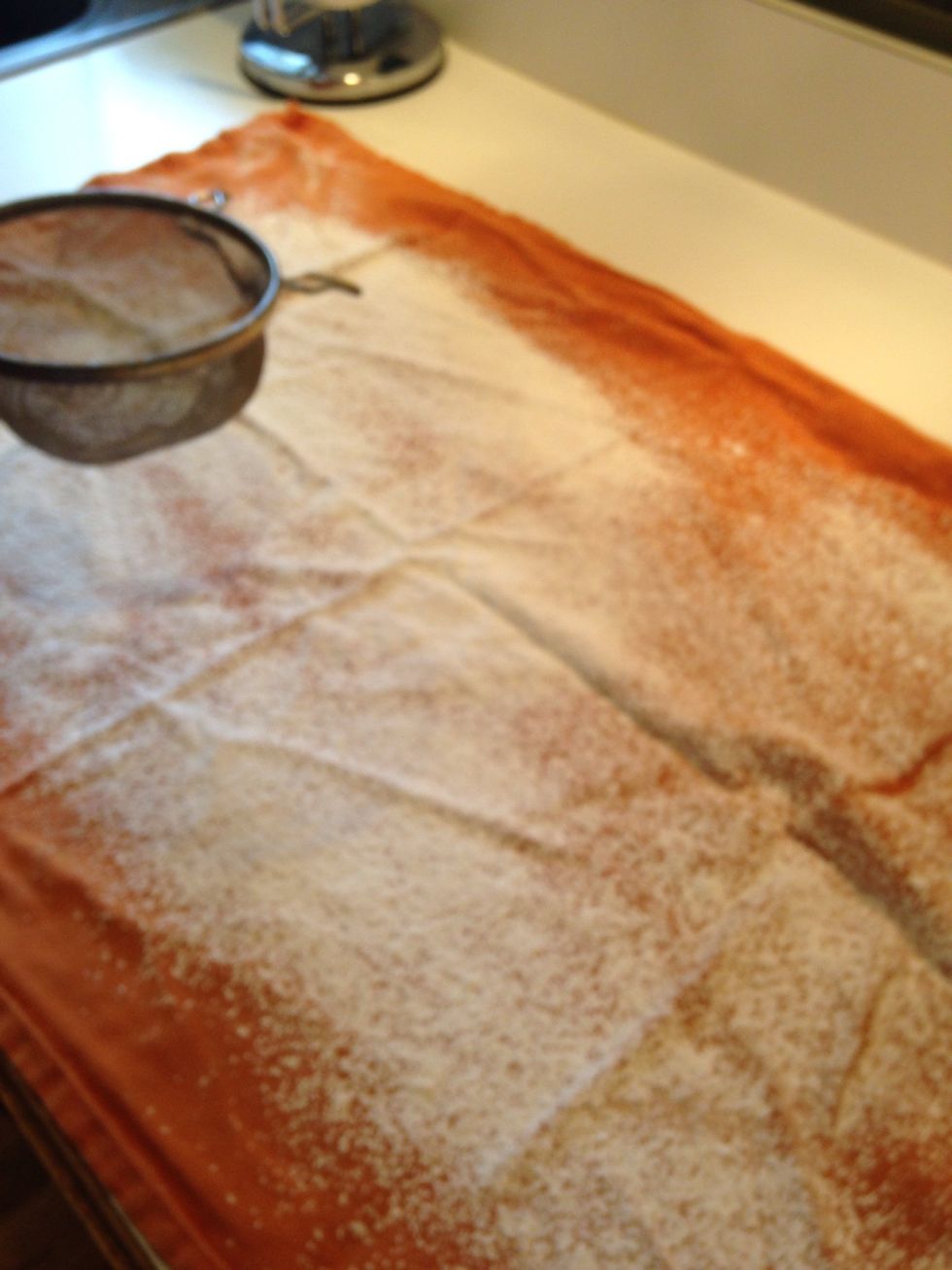 Lay clean tea towel on counter and dust with powdered sugar to prevent sticking.
