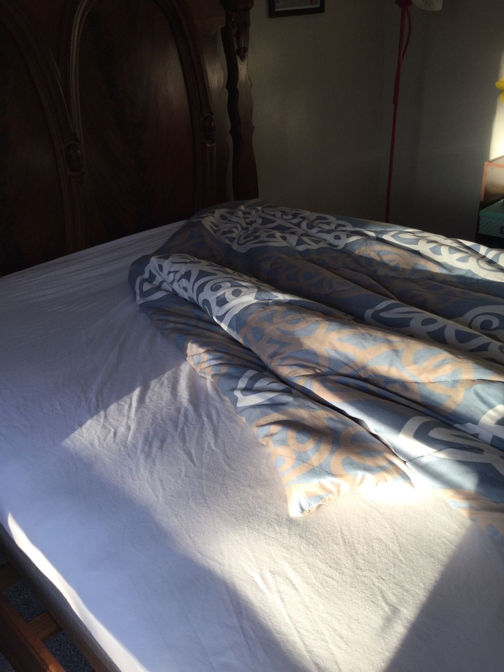 Lay comforter or quilt on top of both sets of sheet