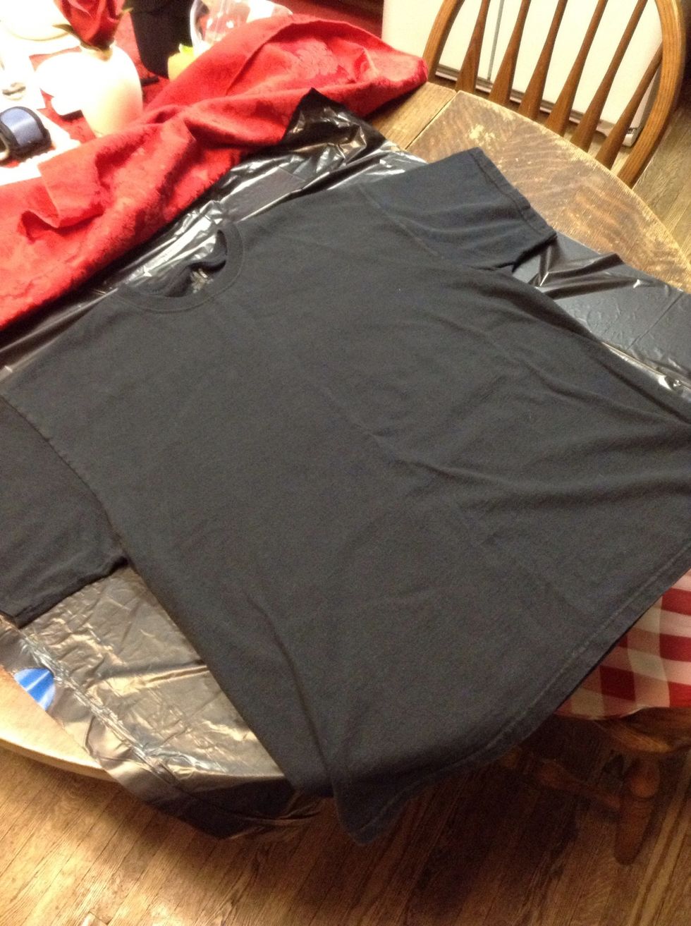 Lay down a work surface, in this case a trash bag! Grab a t-shirt you're not afraid to mess up if you make a mistake. I think black works best, but experiment!