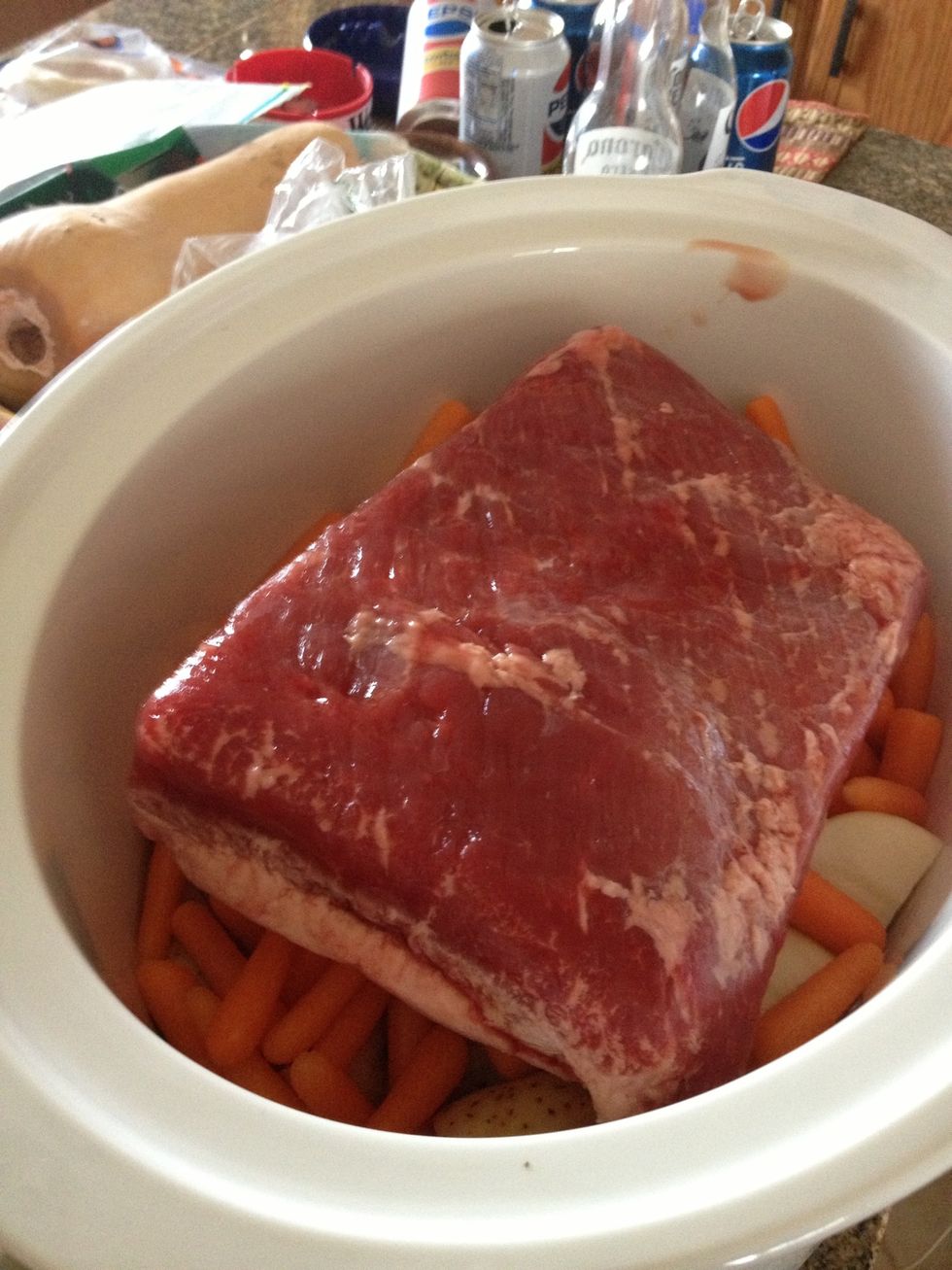 Lay down the meat on top of potatoes and carrots