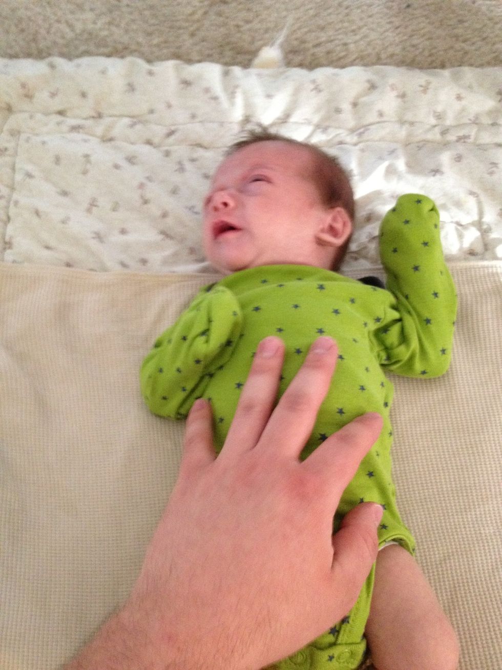Lay fussy baby in the middle upper portion of the blanket.