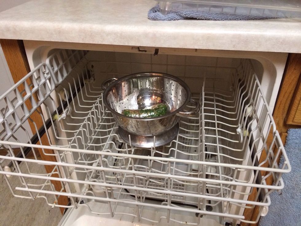 Lay in strainer on top shelf of dishwasher