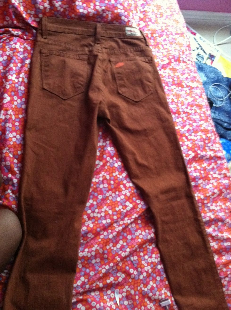 Lay jeans as flat as possible with back pockets facing up.